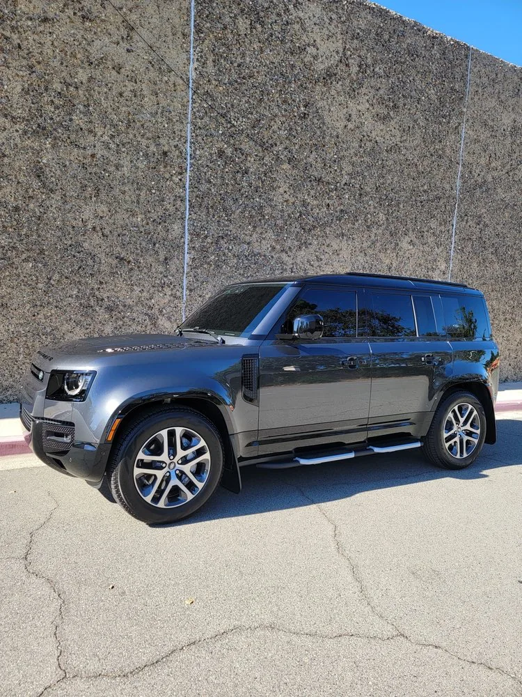 Gray Land Rover Defender with dark window tint