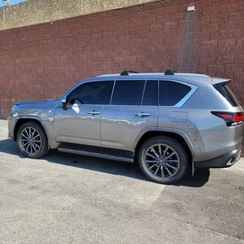 Silver Lexus SUV with finished dark window tint