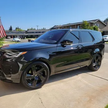 Black SUV with finished window tint in a driveway
